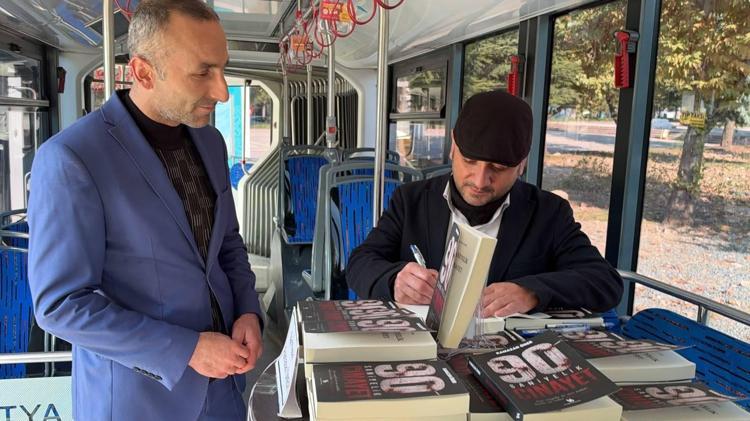 Toplu taşıma aracında yazdığı kitabını trambüste imzaladı